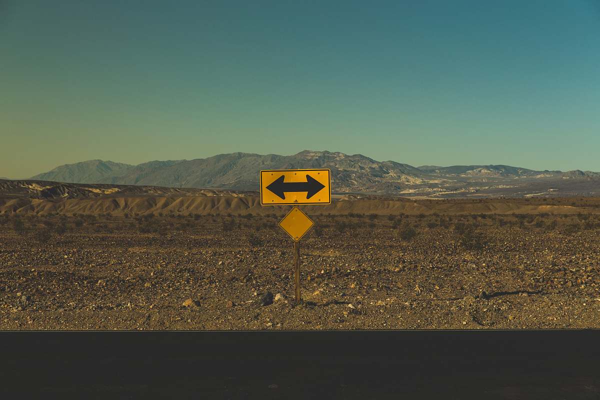 death valley national park yellow arrow road sign furnace creek
